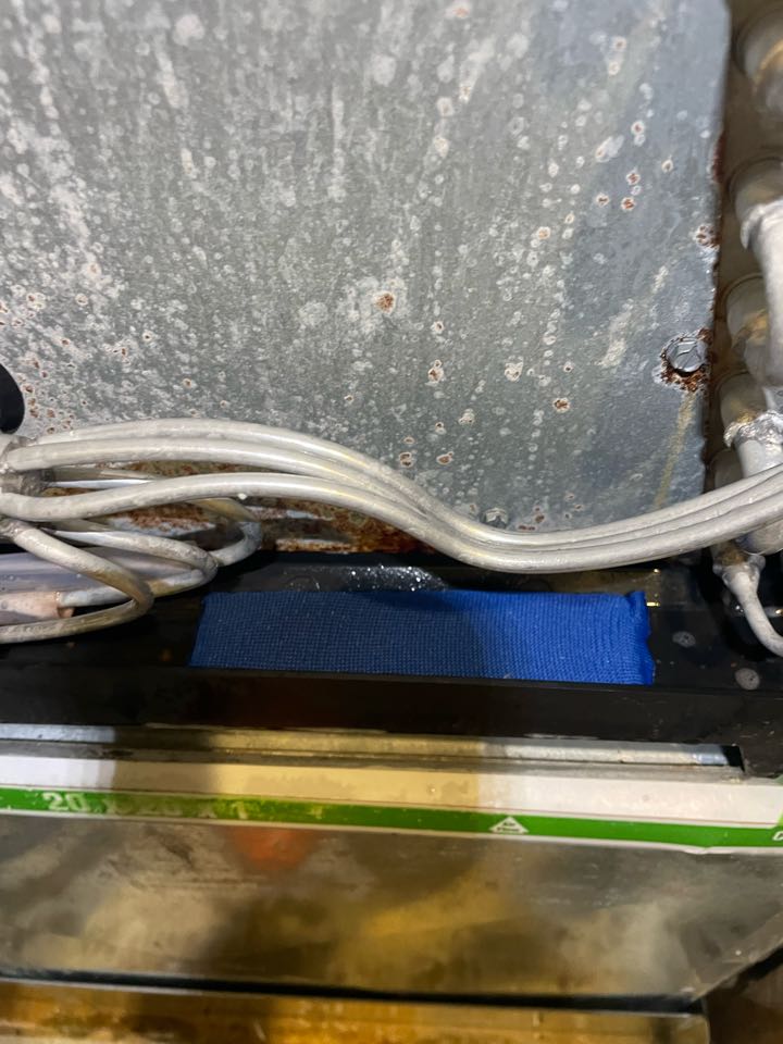 Chesapeake Beach, MD - Installing a drain pan treatment in a Ruud air handler pan to keep the drain from stopping up with stagnant water sludge Chesapeake Beach, MD - Installing a drain pan treatment in a Ruud air handler pan to keep the drain from stopping up with stagnant water sludge