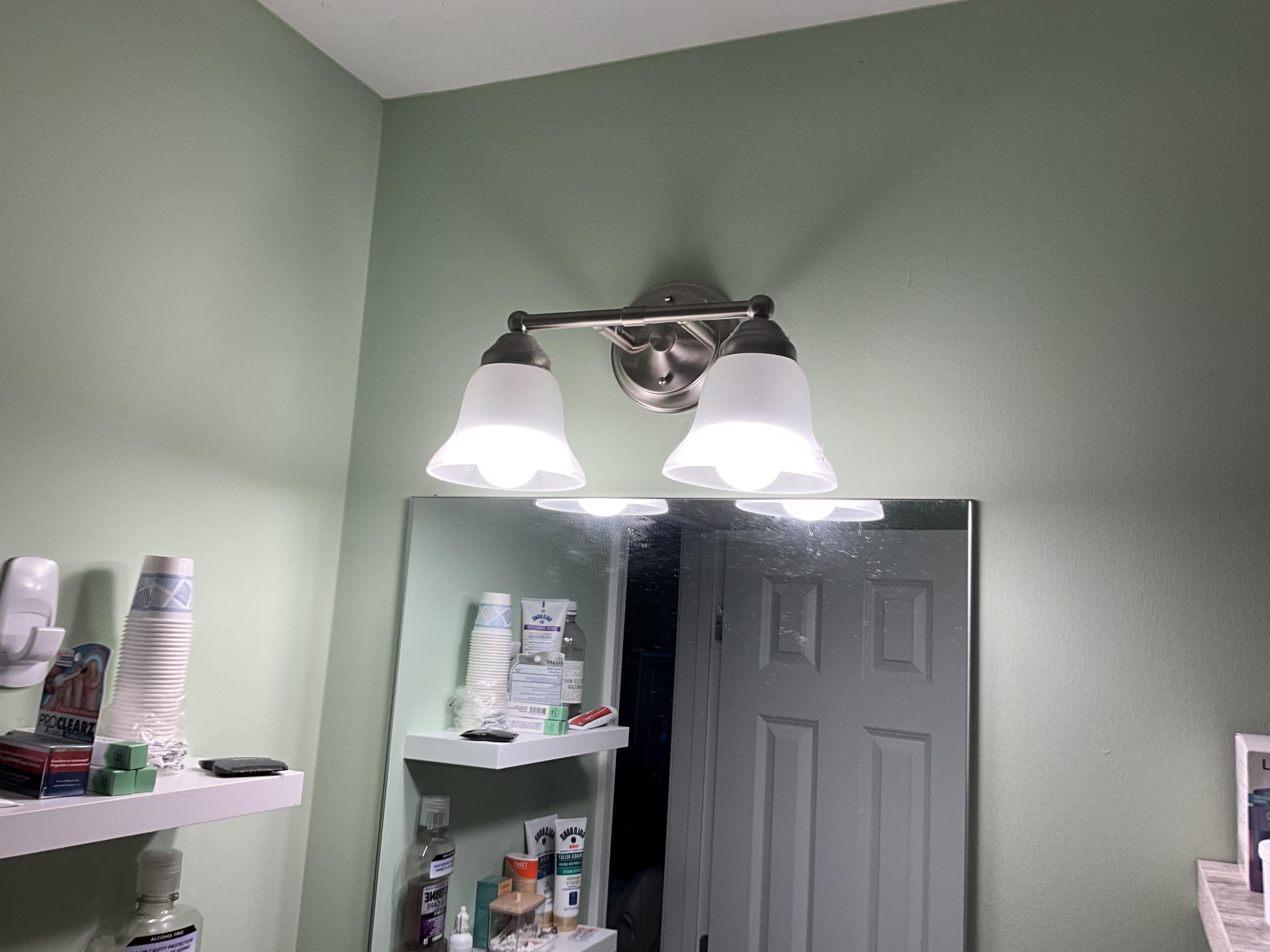 Upon arrival, I conducted a thorough diagnostic evaluation of the bathroom lighting fixture due to flickering reports. I inspected the wiring and switch connections, finding no defects. Further examination revealed that low-quality Great Value bulbs were causing intermittent flickering due to poor socket contact. I replaced these with higher-quality LED EcoSmart bulbs, ensuring proper installation and secure contact. After testing, the flickering was resolved, and the lighting system operated normally and safely.