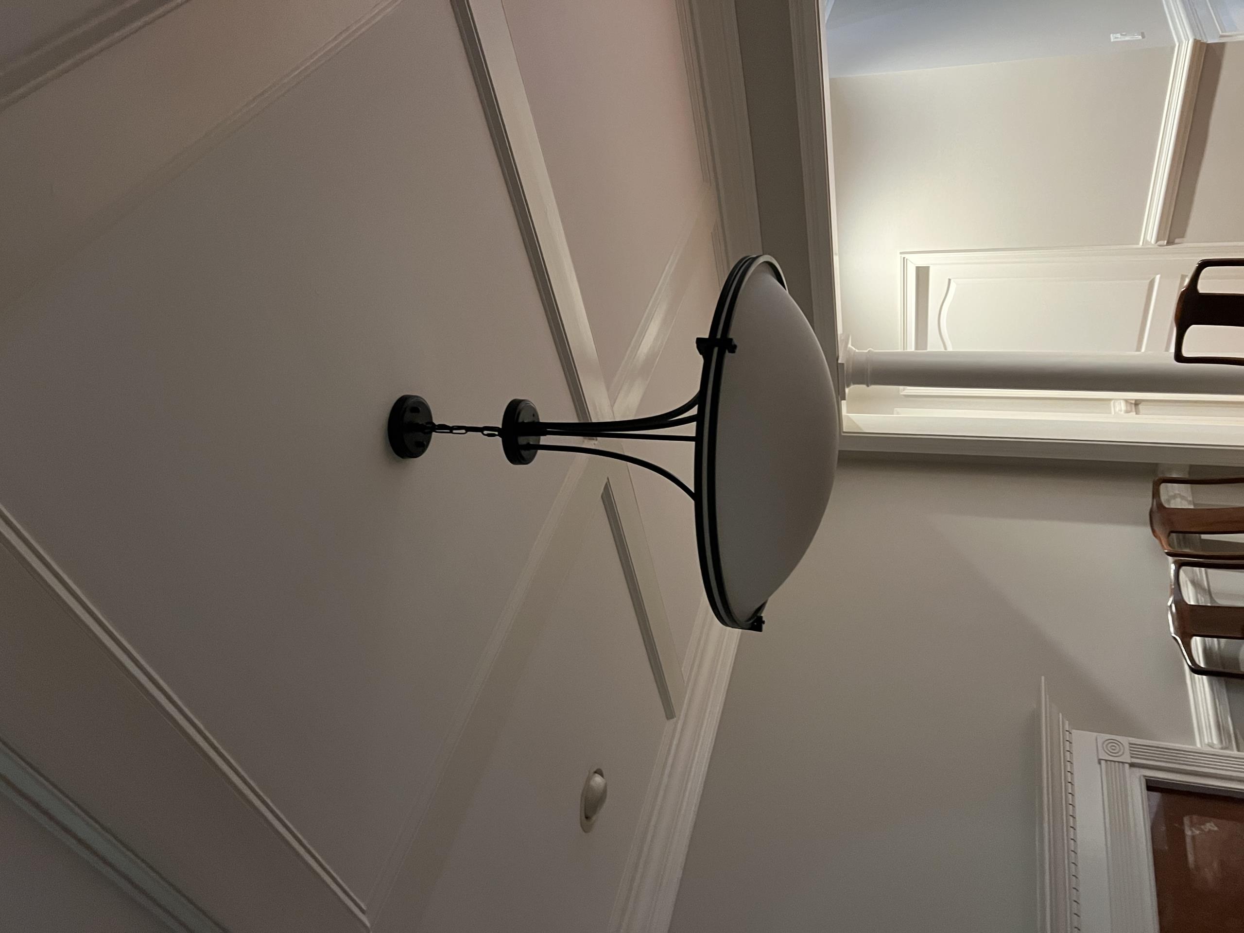 Today, I installed two fan-rated boxes, one in the bedroom and one in the dining room. Additionally, I hung a chandelier in the dining room, a ceiling fan in the living room, and another chandelier in the informal dining area. A fan was also installed in the master bedroom. During the work, I identified a loose neutral and several master-slave switch concerns. I temporarily fixed a faulty three-way switch in the master bedroom. The living room light fixture was hung but did not function due to a potential transmitter issue. The customer refused to pay for the completed work.