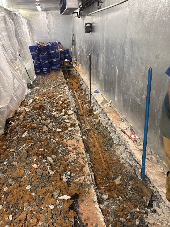 Jackhammering the slab to replace a main waterline