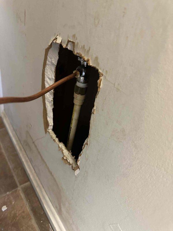 Completed installation of customer-supplied powered humidifier. Work included cutting wall access opening to connect copper water supply line to the humidifier, installing water shutoff valve with PVC drainage, and mounting the ventilation unit with proper PVC drain line configuration. System was tested and confirmed operational.