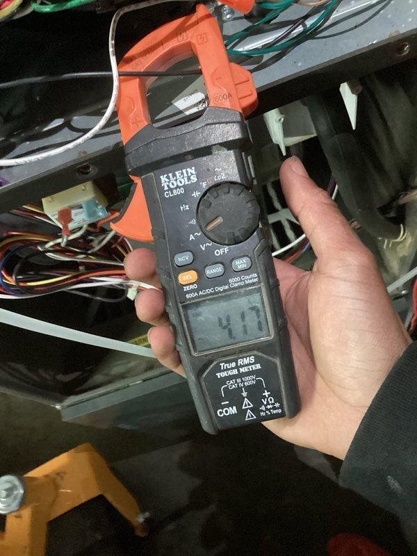 Performed maintenance service on a 2-year-old HVAC system during initial site visit. Conducted electrical diagnostics using a clamp meter, recording amperage measurements of 4.17A. Inspected gas burner assembly, confirming proper ignition with consistent blue flames across all four burners and verifying gas valve functionality.