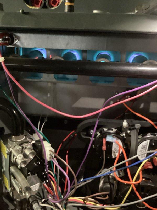 Performed maintenance service on a 2-year-old HVAC system during initial site visit. Conducted electrical diagnostics using a clamp meter, recording amperage measurements of 4.17A. Inspected gas burner assembly, confirming proper ignition with consistent blue flames across all four burners and verifying gas valve functionality.