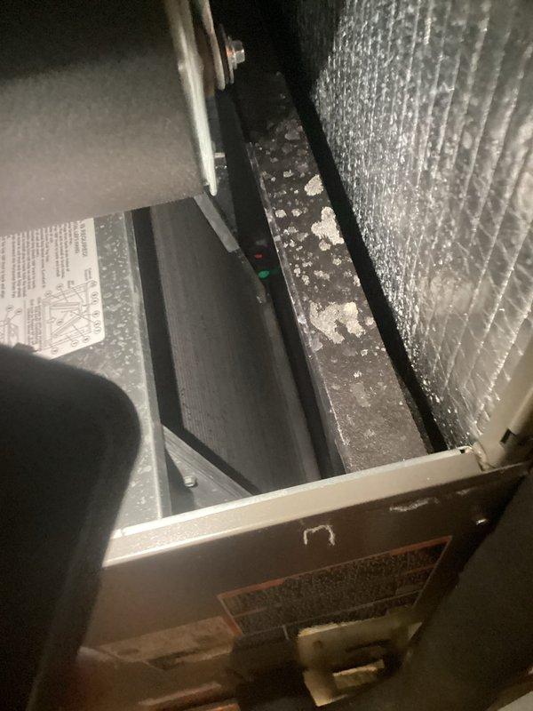 Performed routine maintenance on a 5-month-old NSSU CFI system during first scheduled visit. Inspected interior components which showed normal dust accumulation on metal surfaces. Replaced air filter with new unit, ensuring proper installation for optimal airflow and system performance.