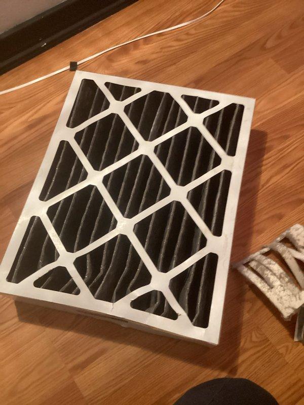 Performed routine maintenance on a 5-month-old NSSU CFI system during first scheduled visit. Inspected interior components which showed normal dust accumulation on metal surfaces. Replaced air filter with new unit, ensuring proper installation for optimal airflow and system performance.