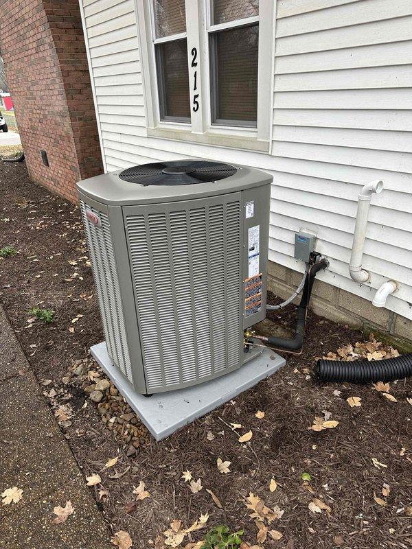 Completed installation of Goodman 4-ton 18 SEER 99% efficiency furnace system at residential property #215. Work included properly mounting outdoor condensing unit on concrete pad with proper clearances and installing tankless water heater on brick wall with appropriate gas lines and PVC venting configured to manufacturer specifications.