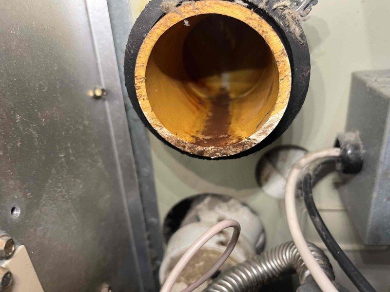 Responded to service call for 20+ year-old heating system with no operation. Diagnosed failed thermostat (no display) and significant corrosion in exhaust flue. Visual inspection revealed damaged wiring connections and deteriorated internal components. Presented repair options and provided replacement system quote as requested by homeowner due to system age and extent of deterioration.