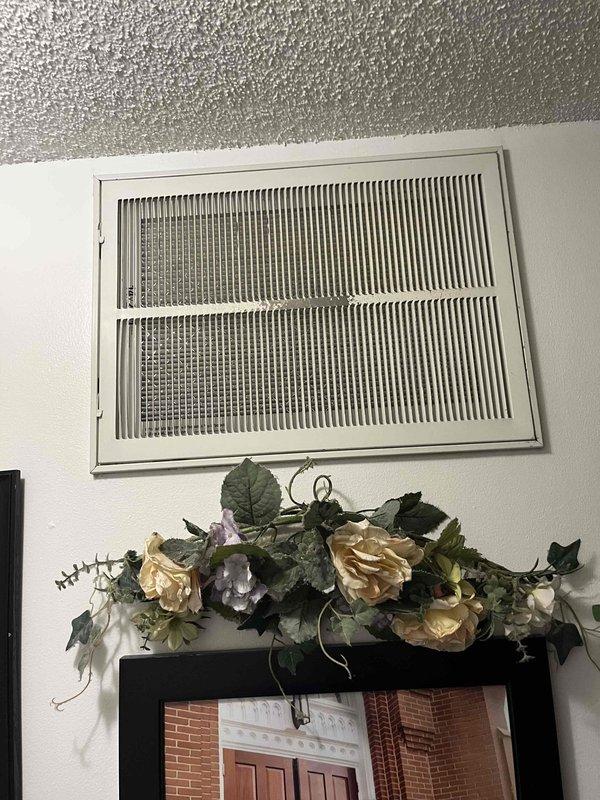 Inspected existing HVAC system at customer's request via Justin. Evaluation revealed aging condenser unit mounted on concrete pad showing significant rust on fan grille, weathered housing with staining, and deteriorated insulation on refrigerant lines. Interior inspection included examination of air vent/return grille placement and condition. Recommended full system replacement due to age-related deterioration and potential efficiency issues.