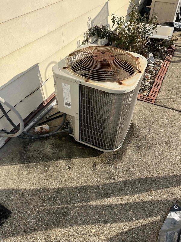 Inspected existing HVAC system at customer's request via Justin. Evaluation revealed aging condenser unit mounted on concrete pad showing significant rust on fan grille, weathered housing with staining, and deteriorated insulation on refrigerant lines. Interior inspection included examination of air vent/return grille placement and condition. Recommended full system replacement due to age-related deterioration and potential efficiency issues.