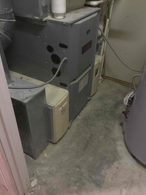 Conducted on-site evaluation for a furnace replacement. Current installation features an aging gray furnace with standard PVC venting in a confined utility area with minimal clearance. Documented existing system configuration and auxiliary components for accurate replacement quote. Customer has been informed of replacement options.