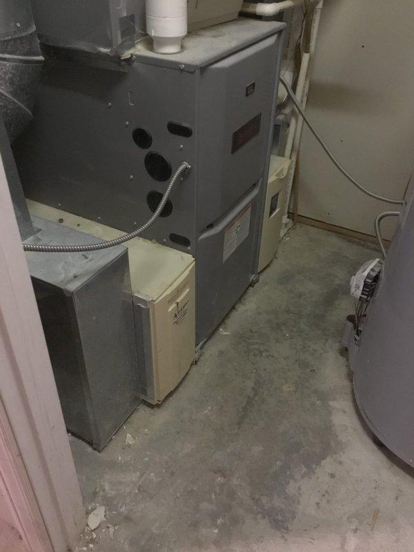 Conducted on-site evaluation for a furnace replacement. Current installation features an aging gray furnace with standard PVC venting in a confined utility area with minimal clearance. Documented existing system configuration and auxiliary components for accurate replacement quote. Customer has been informed of replacement options.