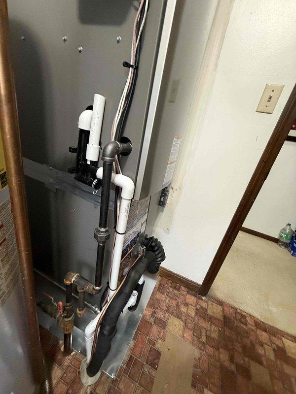 Successfully installed a complete GREEN3T HVAC system with model number 18 99 DS. The installation included proper connection of the furnace unit with PVC venting and integration with the existing water heater system. All components were properly mounted, connected, and tested for optimal performance.