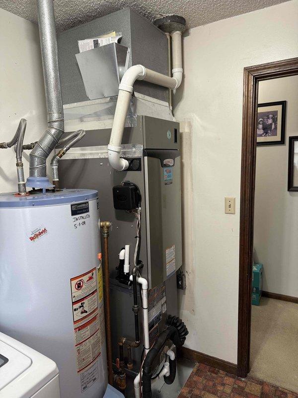Successfully installed a complete GREEN3T HVAC system with model number 18 99 DS. The installation included proper connection of the furnace unit with PVC venting and integration with the existing water heater system. All components were properly mounted, connected, and tested for optimal performance.