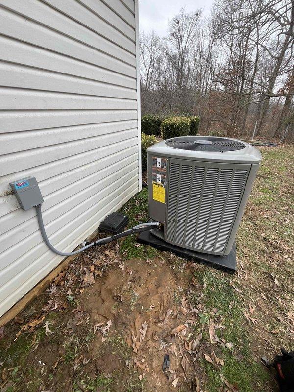 Completed installation of a Green5T 18S 99UP HVAC system at customer's residence. Indoor work included installation of furnace unit with complete ductwork system and appropriate PVC venting. Outdoor unit was properly mounted on concrete pad with electrical connections secured to the home's exterior, though some ground erosion was noted around the pad area.