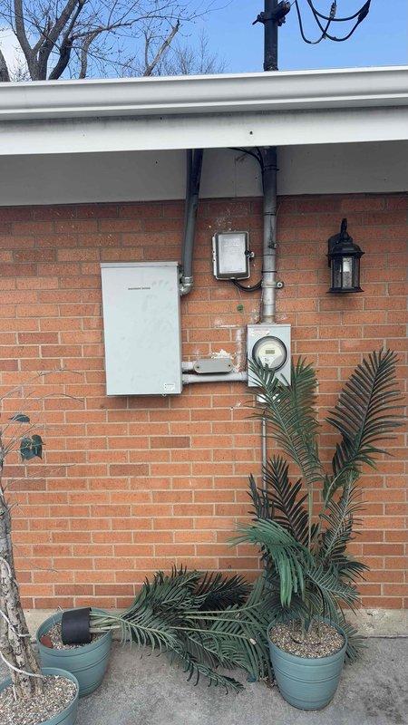 Conducted comprehensive site evaluation for generator installation. Inspected existing electrical service panel, conduit placement, and utility meter configuration on exterior brick wall. Assessed HVAC furnace and water heater setup in utility space to determine optimal generator integration points and ensure compatibility with household systems.