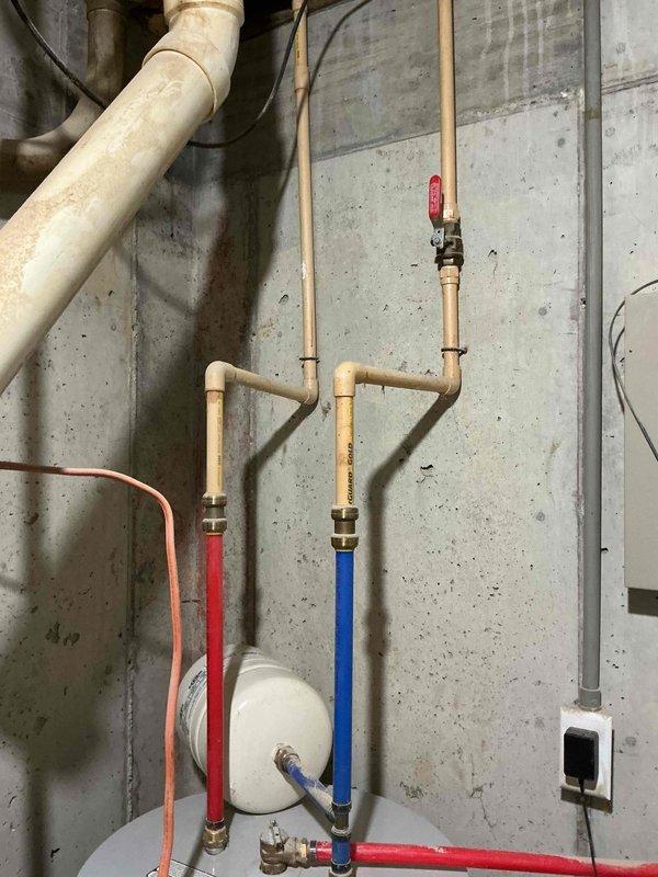 Conducted estimate for a 40-gallon electric water heater replacement, discussing tankless options and gas line extension possibilities as requested by homeowner. Current installation features standard electric water heater with PVC piping system, proper hot/cold water lines, and expansion tank all in good working condition. Presented options for both electric replacement and conversion to gas, including requirements for running gas line to current installation location.