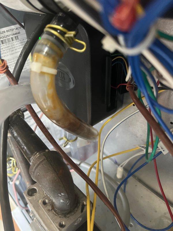 Performed annual planned maintenance service on HVAC system installed July 2025. Inspected condensate drain system showing normal discoloration from use and verified proper drainage. Examined documentation holder and control panel wiring connections, confirming all components are functioning correctly with no issues requiring immediate attention.