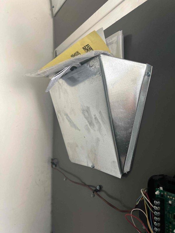 Performed annual planned maintenance service on HVAC system installed July 2025. Inspected condensate drain system showing normal discoloration from use and verified proper drainage. Examined documentation holder and control panel wiring connections, confirming all components are functioning correctly with no issues requiring immediate attention.