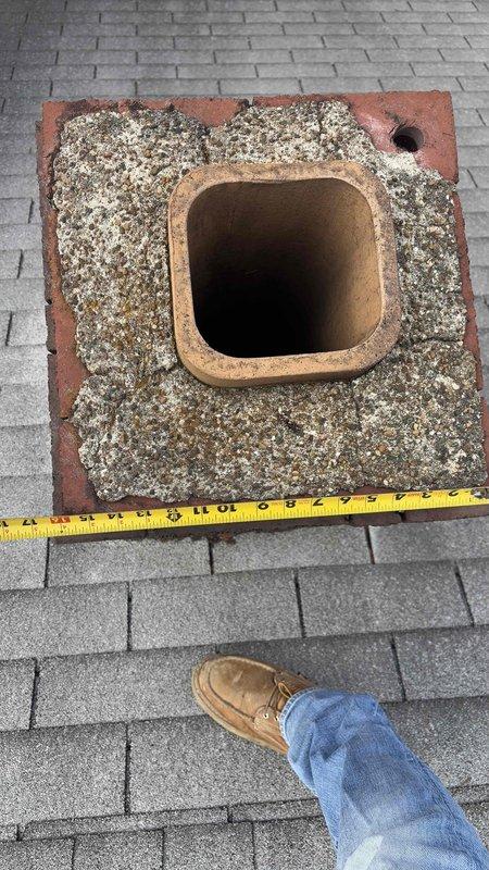 Performed roof inspection to assess rerouting options for 80% furnace and water heater currently vented through deteriorating chimney. Documented measurements and evaluated structural integrity of existing terracotta flue liner and masonry base, which showed significant weathering and debris accumulation. Confirmed customer's concerns about potential aesthetic and safety issues with proposed 12ft roof penetration alternative.