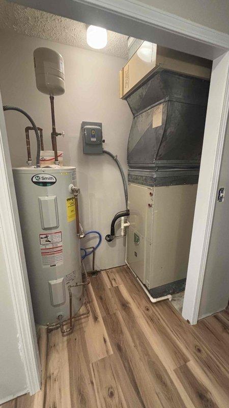Conducted a comprehensive evaluation of the existing HVAC system for Jenny (executor of mother's estate) who expressed interest in both geothermal and traditional replacement options. Inspected the current equipment including the AO Smith water heater and connected HVAC components with ductwork, documenting the mechanical room setup with detailed photos for accurate replacement specifications and future reference.