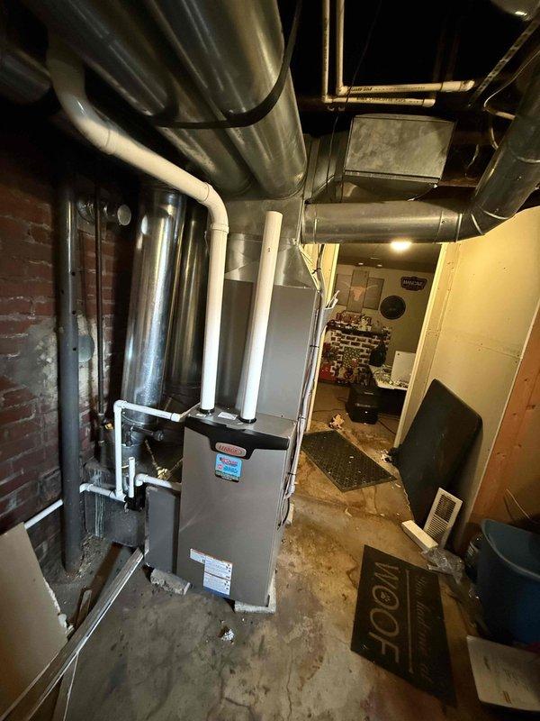 Completed installation of a 2.5-ton, 15.5 SEER complete HVAC system with 97% efficiency upflow furnace and 50-gallon electric water heater. System includes new ductwork, PVC exhaust venting, and all necessary plumbing connections as documented in photos.