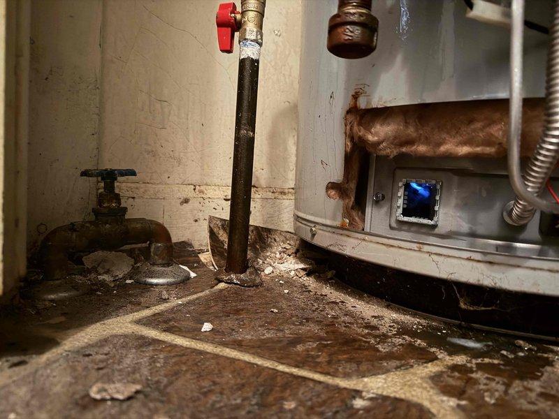 Responded to call back for water heater pilot light failure. Diagnosed that unit had overheated, requiring reset of temperature sensor. Successfully reset sensor using appropriate code and relit water heater. Confirmed unit is now operational with proper flame.