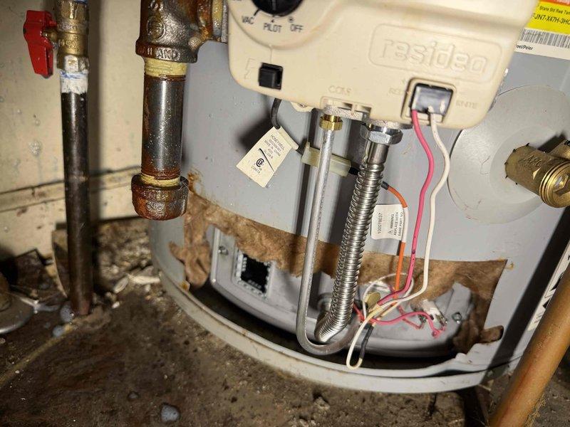 Responded to call back for water heater pilot light failure. Diagnosed that unit had overheated, requiring reset of temperature sensor. Successfully reset sensor using appropriate code and relit water heater. Confirmed unit is now operational with proper flame.