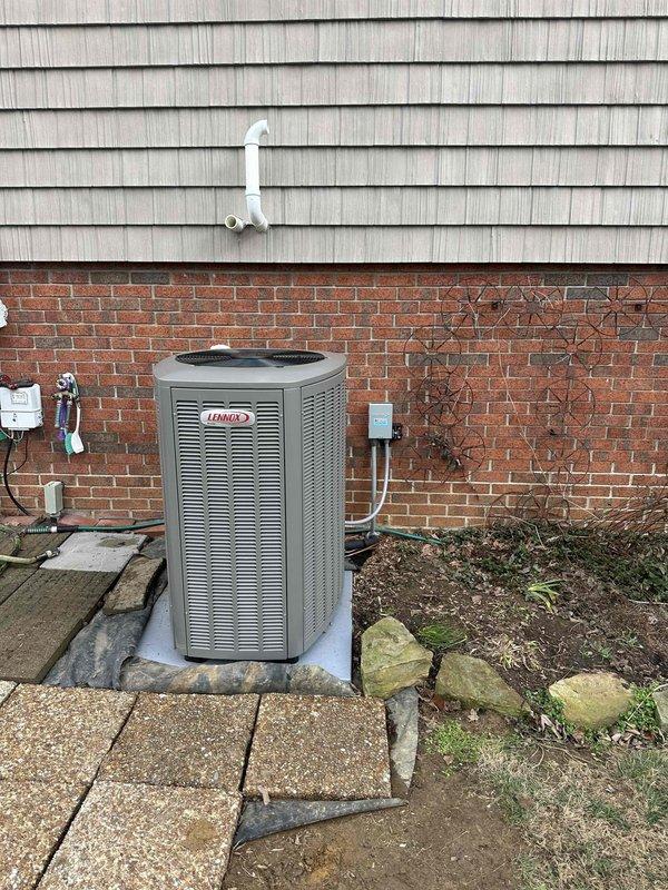 Successfully completed full HVAC system installation, featuring a new Lennox air conditioning unit mounted on concrete pad with proper electrical connections and condensate drainage. Interior components include furnace system with PVC ventilation piping installed in utility room, completing the 3-ton system upgrade as specified in work order.