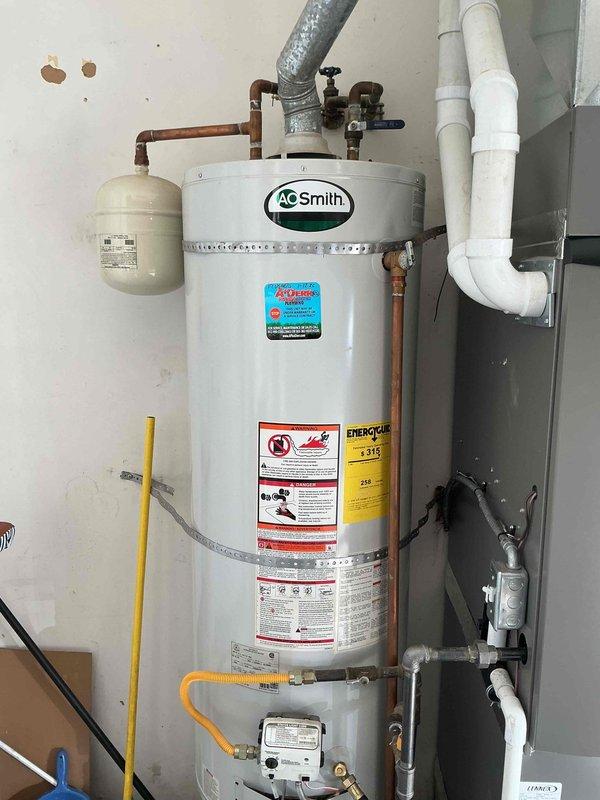 Performed routine maintenance on customer's A.O. Smith tanked water heater, completing a comprehensive flush to remove sediment buildup and restore optimal efficiency. Inspected all connections, valves, and the pressure relief system, confirming proper operation and absence of leaks. Water heater is now functioning efficiently with improved performance and extended lifespan.