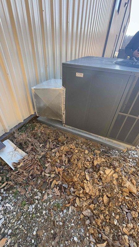 Conducted site visit for Mr. Tim to provide estimate for reinstallation of disconnected HVAC unit following building expansion. Inspected indoor components including ceiling-mounted air handler with insulated vertical ductwork and packaged equipment awaiting installation. Evaluated outdoor condenser unit positioned against metal exterior wall with associated ventilation components to determine reconnection requirements and scope of work.