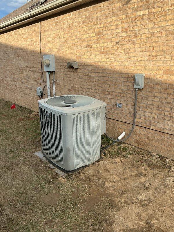 Conducted comprehensive assessment of existing HVAC system for replacement quote. Documented aging exterior condensing unit showing signs of weathering, mounted on concrete pad with associated electrical disconnect box and conduit. Also examined Honeywell digital thermostat which appeared to be non-operational during inspection.