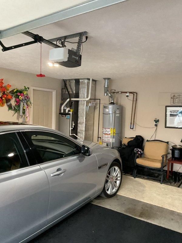 Responded to water leak issue where HVAC exhaust vent had separated in attic space, causing water to drip through garage ceiling and damage drywall. Inspected attic area, identified point of separation in metal ductwork, and repaired connection to prevent further water intrusion and damage to the 2-year-old system.