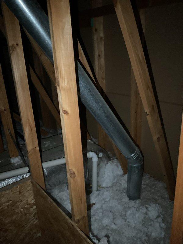 Responded to water leak issue where HVAC exhaust vent had separated in attic space, causing water to drip through garage ceiling and damage drywall. Inspected attic area, identified point of separation in metal ductwork, and repaired connection to prevent further water intrusion and damage to the 2-year-old system.