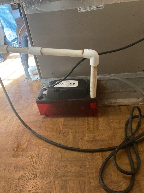 Responded to customer concern regarding loud noise and unusual indicator lights on 17-year-old HVAC system. Diagnosed issue with condensate removal system and installed new condensate pump. Connected proper PVC drainage assembly with appropriate fittings to ensure proper water evacuation from unit. System now operating normally with all warning lights cleared.