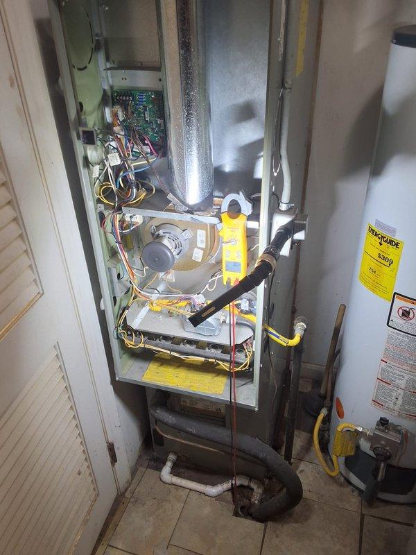 Performed diagnostic assessment on 5-7 year old furnace system responding to customer concerns. Opened access panel to inspect circuit board and electrical connections, utilizing clamp meter to test wiring integrity and component functionality. System was operational during visit with adequate airflow through vents, and no immediate critical issues were identified requiring repair.