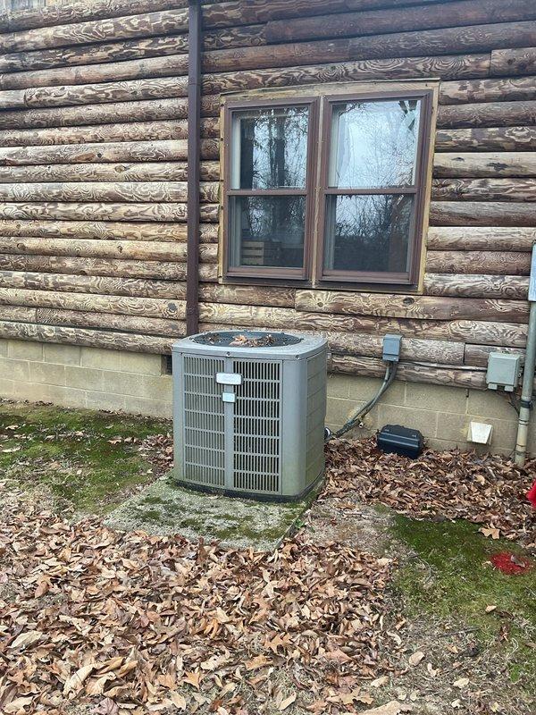 Conducted a comprehensive HVAC replacement estimate for a log cabin currently using propane heating system. Evaluated existing outdoor condenser unit located on concrete pad adjacent to the cabin exterior and reviewed system specifications via technical diagrams. Customer expressed interest in exploring both propane retention and electric conversion options for improved efficiency.