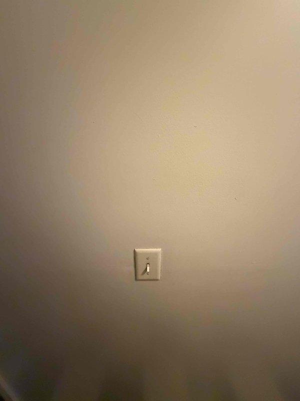 Responded to a service call regarding water leakage from shower through wall, affecting a hallway light switch. Conducted visual inspection of the affected area, documented current condition with photos. No visible water damage observed on wall surface or switch plate at time of inspection.