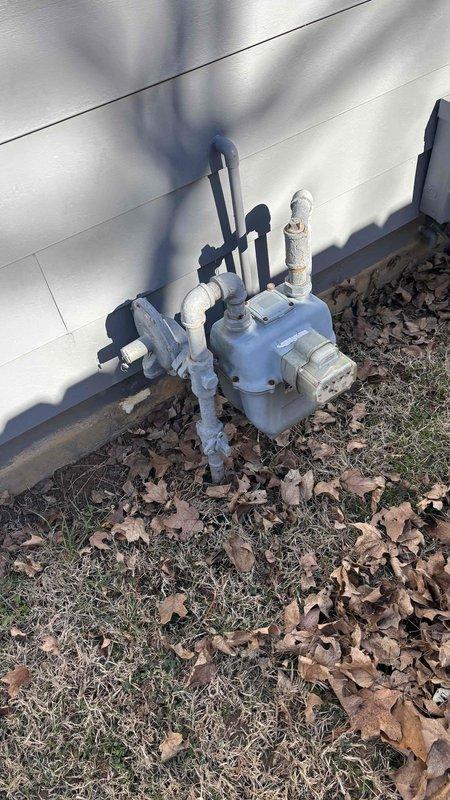 Conducted comprehensive assessment of 30-year-old HVAC system and 18-year-old water heater for potential replacement. Inspected and documented existing gas meter installation with associated piping connections to evaluate capacity for new equipment. Customer expressed interest in free water heater promotion with complete system replacement.
