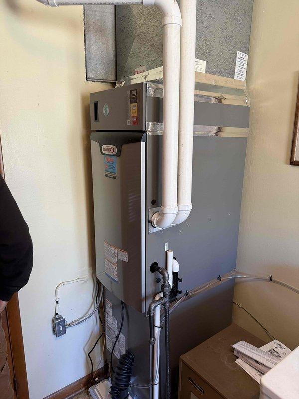 Successfully completed installation of a complete 2.5-ton, 15.5 SEER Lennox HVAC system with 97% efficiency furnace. System includes new indoor furnace unit with PVC venting and outdoor condensing unit properly secured on concrete pad with electrical connections to junction box.