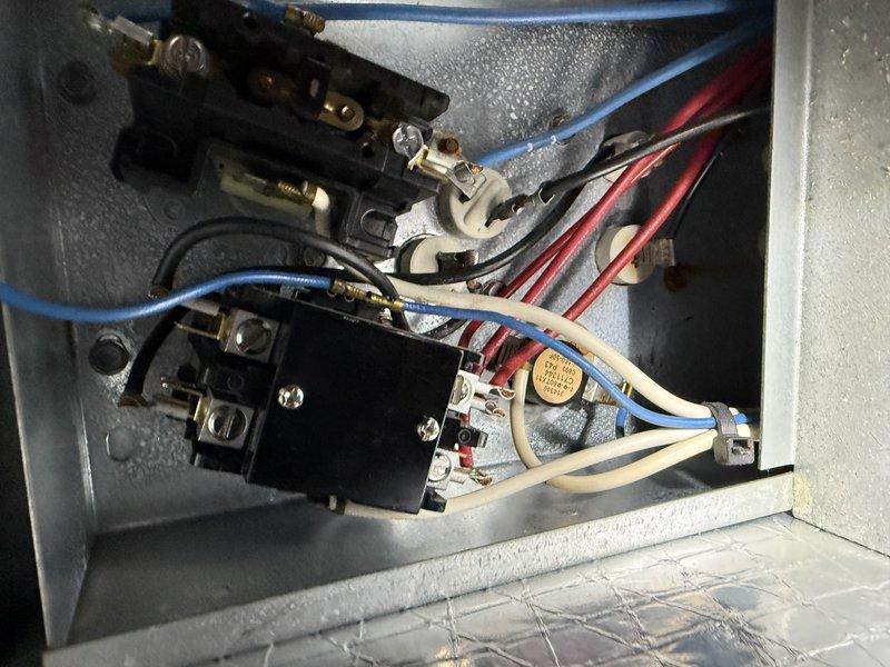 Performed diagnostic assessment on 18-year-old HVAC system after customer reported non-functioning heat strips. Inspection revealed significant corrosion and rust throughout the air handler interior, with visible moisture damage and deterioration of metal components. Examination of the electrical control panel showed signs of condensation with potential electrical hazards, confirming multiple heat strips have failed due to age-related wear and system deterioration.