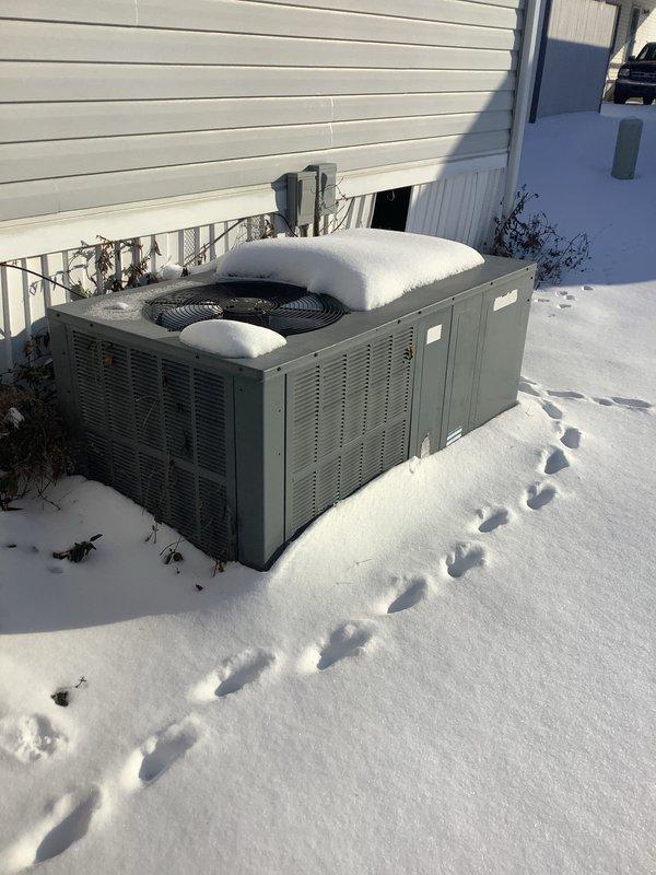 Conducted comprehensive evaluation of existing heat pump system and assessed feasibility of adding a furnace as requested by homeowner. Inspection revealed outdoor heat pump unit covered in snow with proper clearance issues, and identified potential electrical concerns with exposed wiring connections in interior corner. Presented replacement options for a dual fuel system configuration.