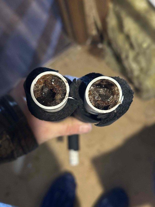 Performed follow-up inspection on previously reported issue with ice formation in inducer. Discovered significant corrosion and buildup in exhaust pipes requiring removal for inspection. Documented condition of severely restricted pipes showing extensive mineral deposits that were impeding proper airflow and contributing to inducer icing problem.