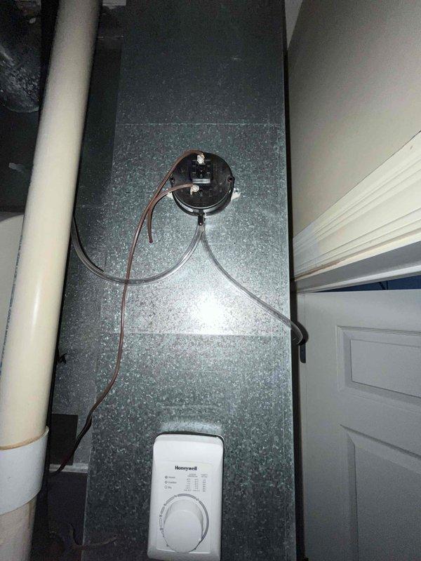 Conducted comprehensive evaluation of existing HVAC system for potential replacement. Inspected current equipment including Honeywell control thermostat, pressure gauge assembly, and main unit with installation documentation. System is operational but customer is exploring green replacement options to improve efficiency and reduce environmental impact.