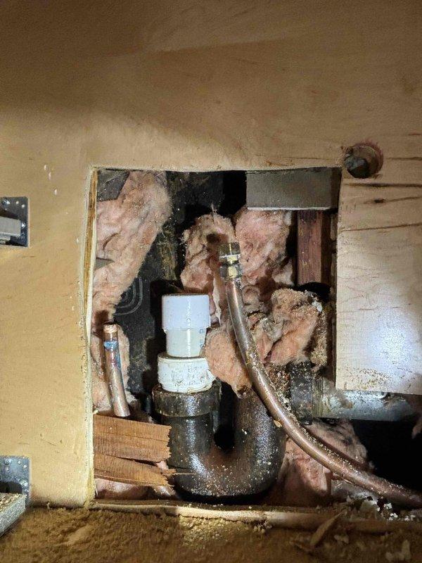 Responded to emergency service call for burst pipe causing low water pressure and no hot water. Upon inspection, accessed wall cavity to examine plumbing infrastructure. Repaired damaged pipe connections and replaced compromised P-trap assembly, restoring proper water flow and hot water functionality.