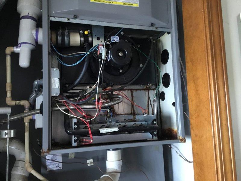 Conducted warranty service inspection on customer Randy James' HVAC system (Job #402778806). Identified collector box requiring replacement, with visible rust and corrosion throughout the interior components. Documented condition with photos and submitted follow-up request for necessary replacement parts.