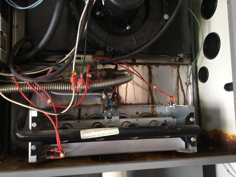 Conducted warranty service inspection on customer Randy James' HVAC system (Job #402778806). Identified collector box requiring replacement, with visible rust and corrosion throughout the interior components. Documented condition with photos and submitted follow-up request for necessary replacement parts.