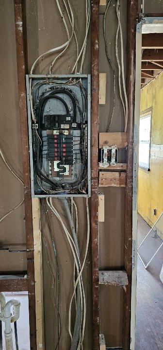 Conducted a replacement estimate for a non-operational HVAC system that hasn't been used in 10 years. Customer is interested in converting to an electric system and inquired about a tankless water heater promotion. Inspection revealed an electrical panel with exposed wiring and an outdated heating unit with metallic ductwork in an unfinished space requiring comprehensive modernization.