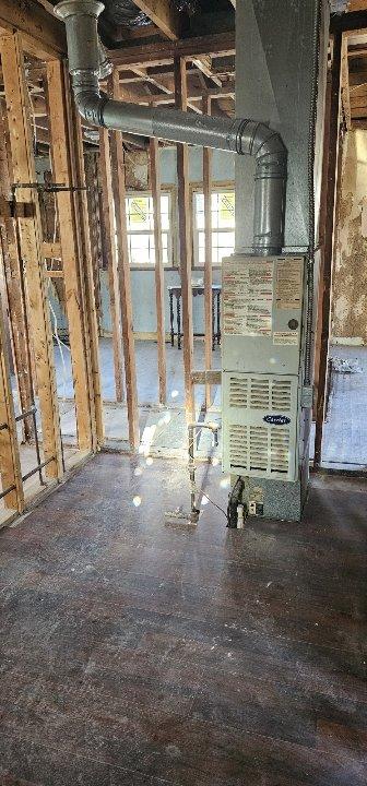 Conducted a replacement estimate for a non-operational HVAC system that hasn't been used in 10 years. Customer is interested in converting to an electric system and inquired about a tankless water heater promotion. Inspection revealed an electrical panel with exposed wiring and an outdated heating unit with metallic ductwork in an unfinished space requiring comprehensive modernization.
