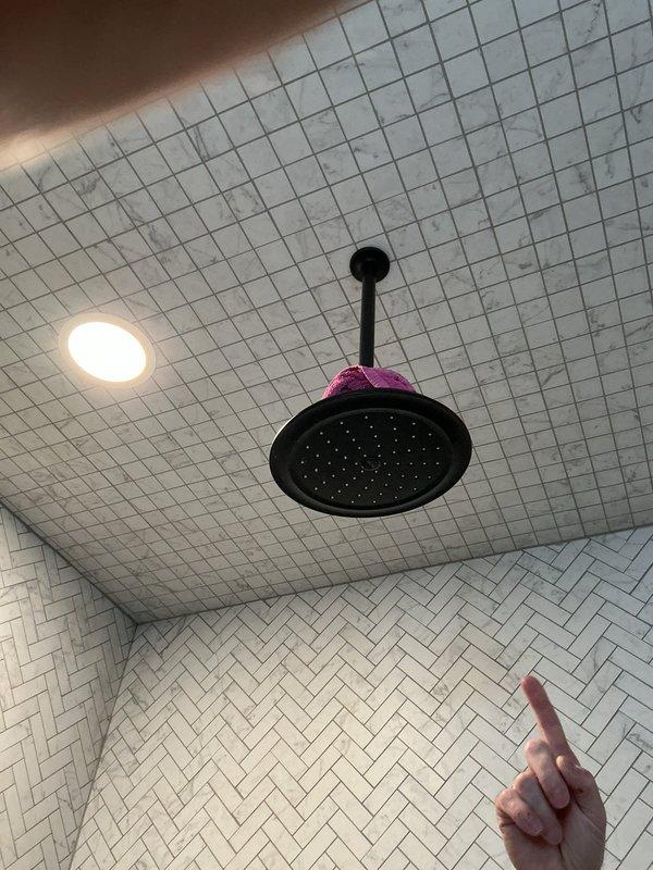 Responded to customer complaint of water leak damaging basement ceiling below master shower. Performed thorough inspection of shower components including the lever-style shower control handle and ceiling-mounted rainfall showerhead. Identified and repaired leak source to prevent further water damage to basement ceiling.