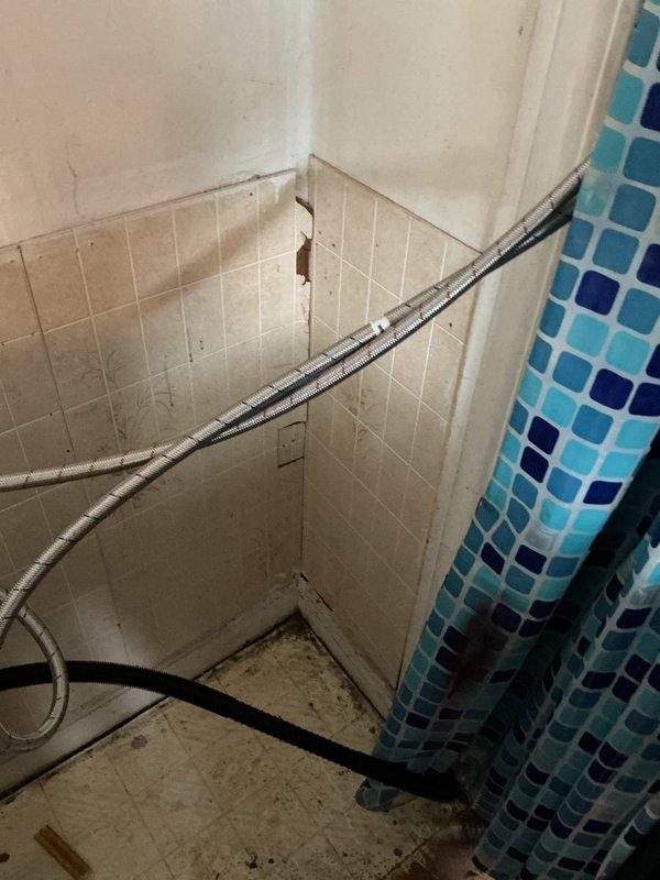 Extended washing machine drain line from current location to connect with the main drainage system. Installed PVC piping with secure metal bracket and connected flexible corrugated hose to ensure proper drainage. System was tested and confirmed to be functioning correctly.